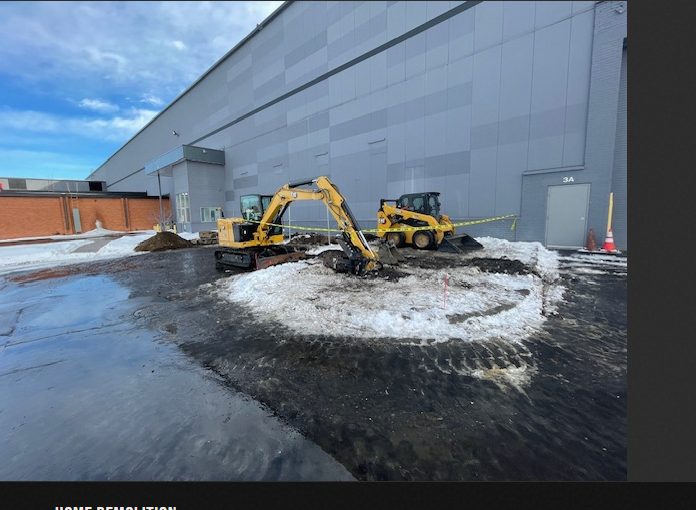 Commercial demolition contractor Minneapolis — excavator and skid steer on commercial site
