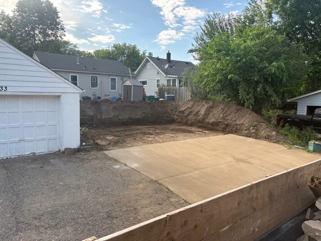 Backyard concrete pad excavation and grading in Minneapolis