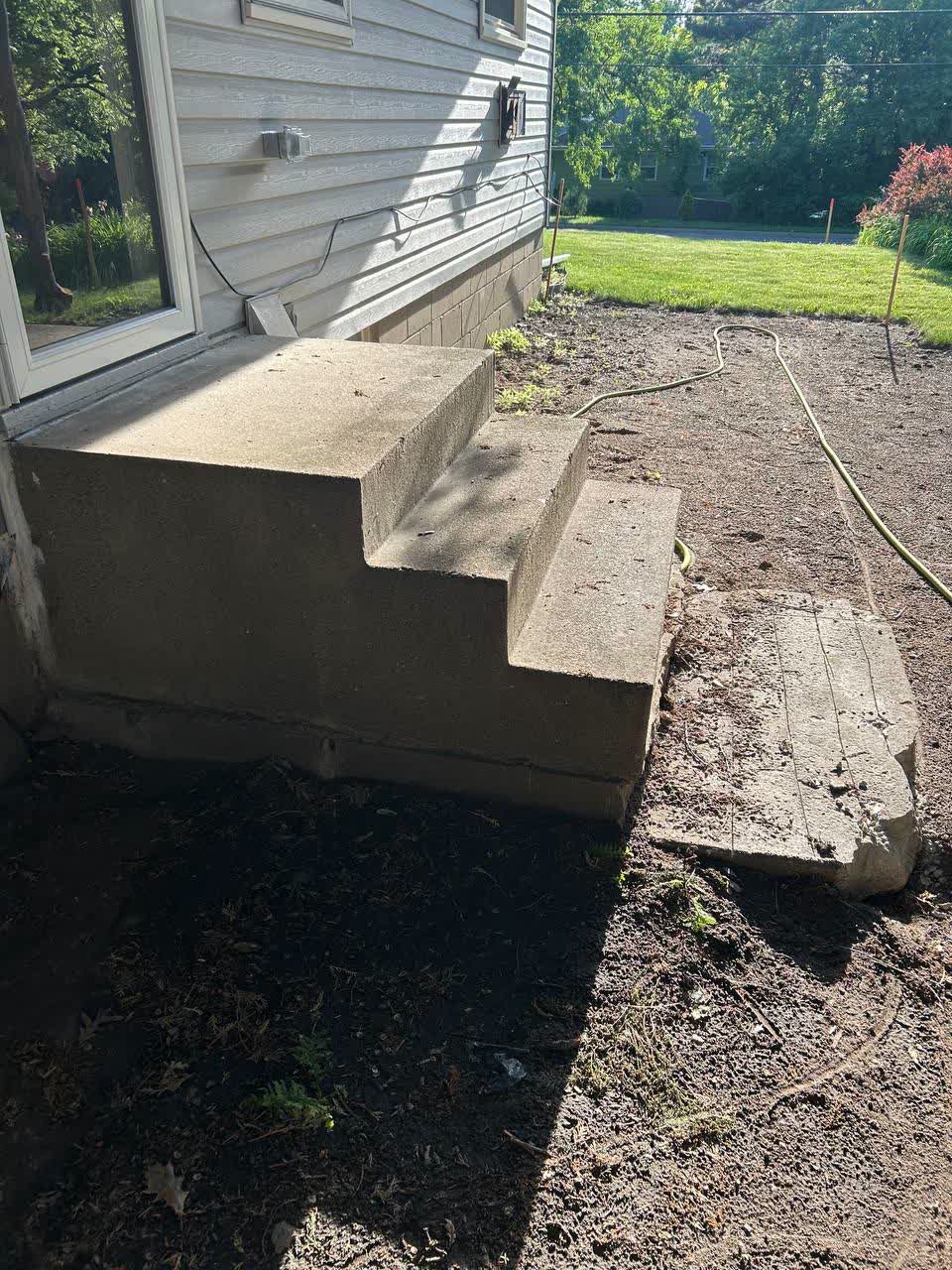 Old concrete stoop staged for removal at a Twin Cities home