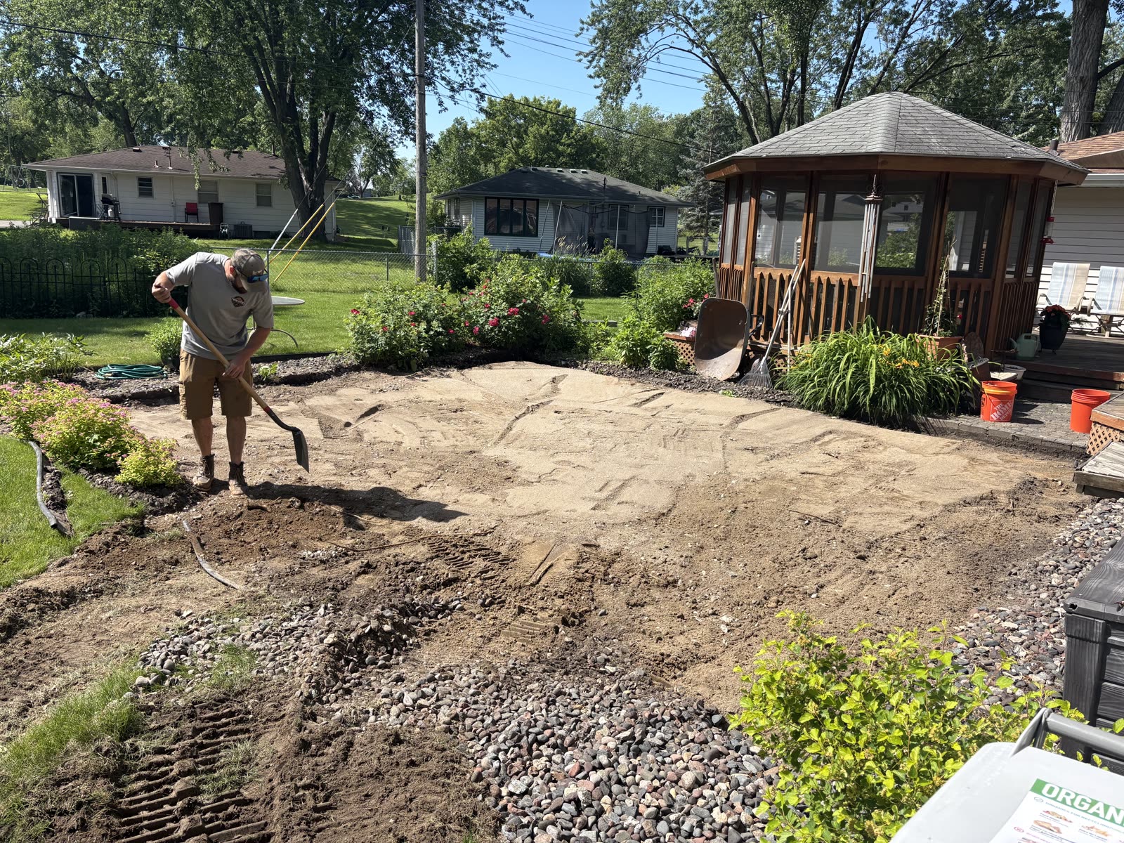 Twin Cities Concrete Demolition owner grading base after patio slab removal, Minneapolis backyard