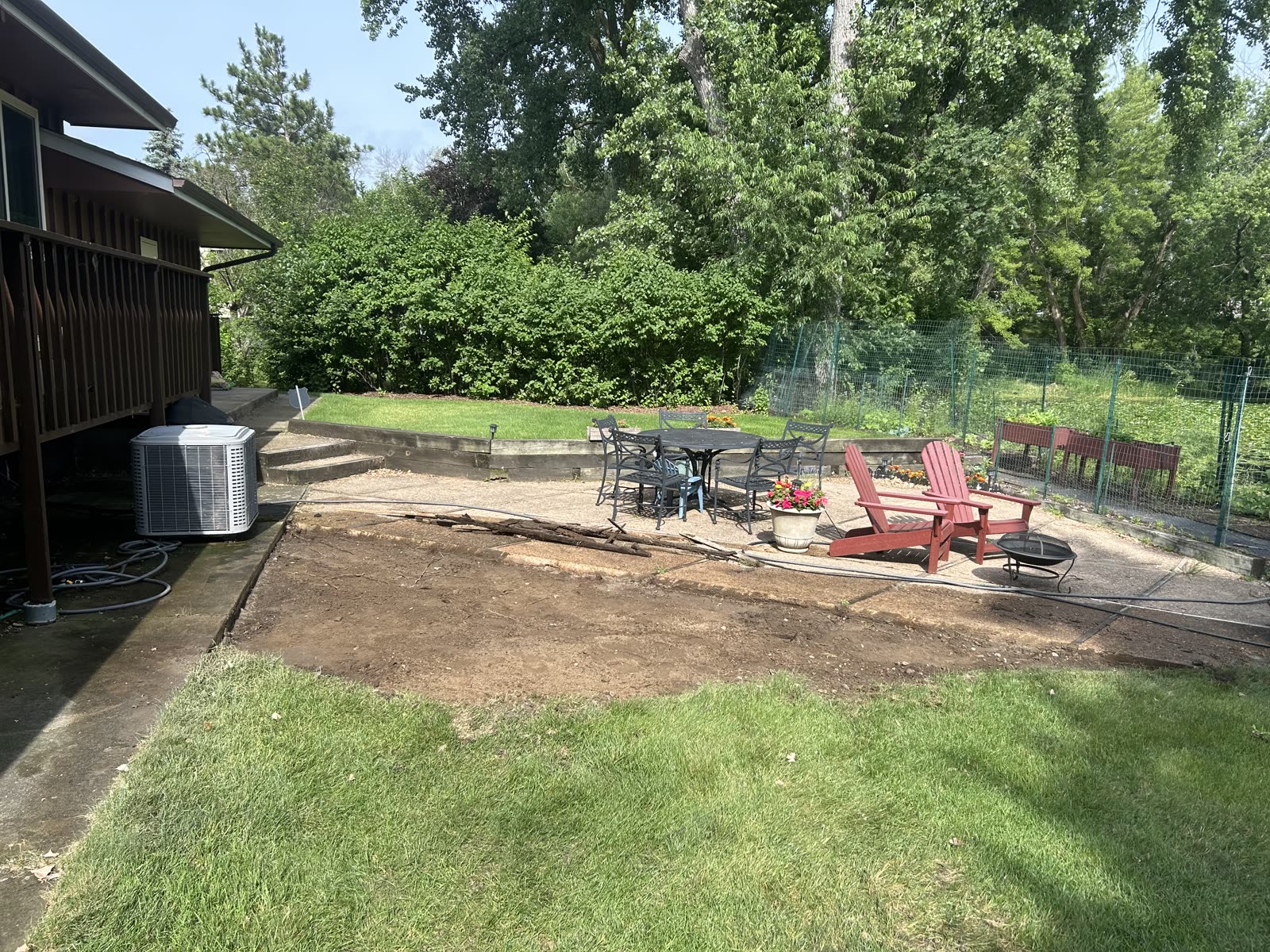 Backyard patio pad after concrete demolition, dirt cleared for new install, Twin Cities MN