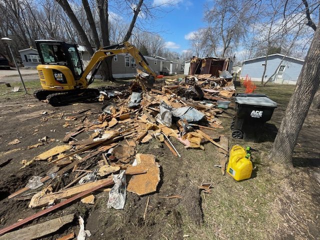 Garage demolition Minneapolis — CAT excavator tearing down detached garage structure Twin Cities