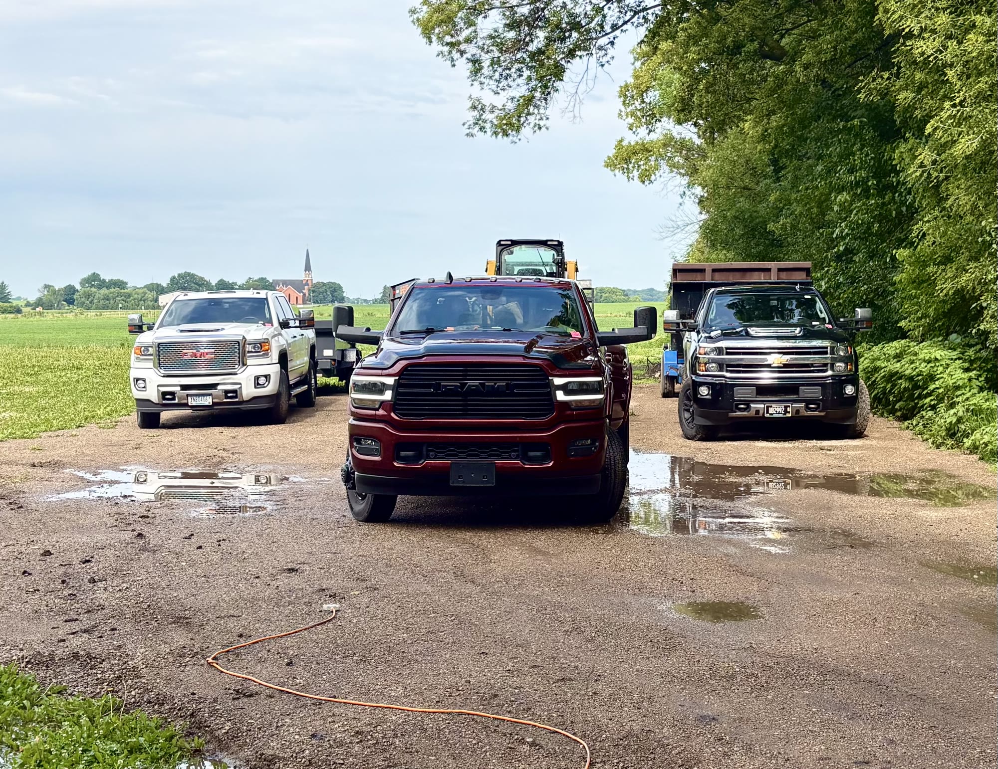 Twin Cities Concrete Demolition fleet — Ram, GMC, Chevy trucks and skid steer ready for Minneapolis / St Paul jobs