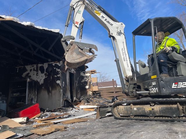Bobcat excavator garage demolition Minneapolis MN
