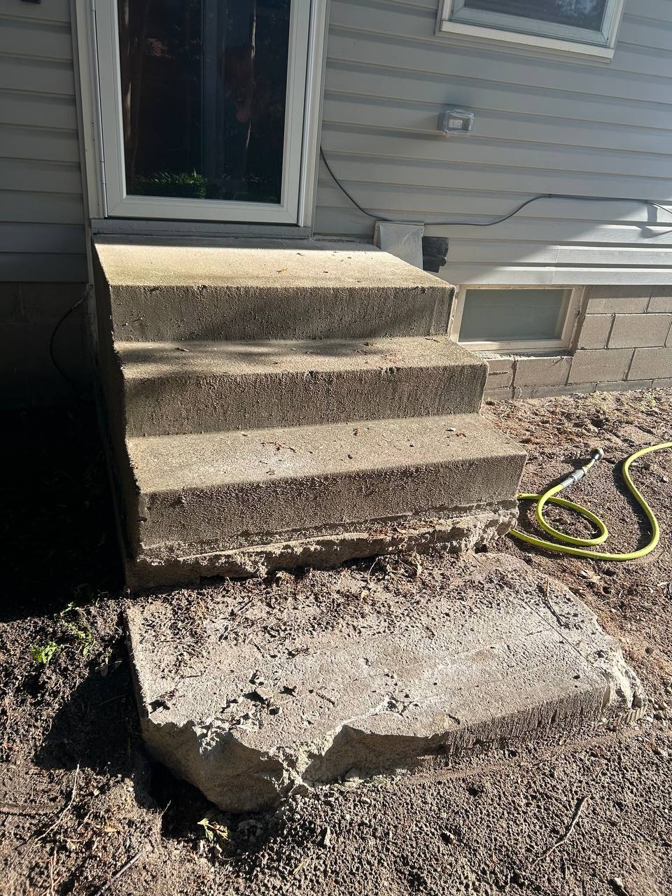 Cracked concrete steps at residential side door, scheduled for removal, Minneapolis MN