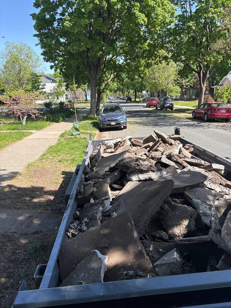 Dump trailer fully loaded with broken concrete on Minneapolis residential street