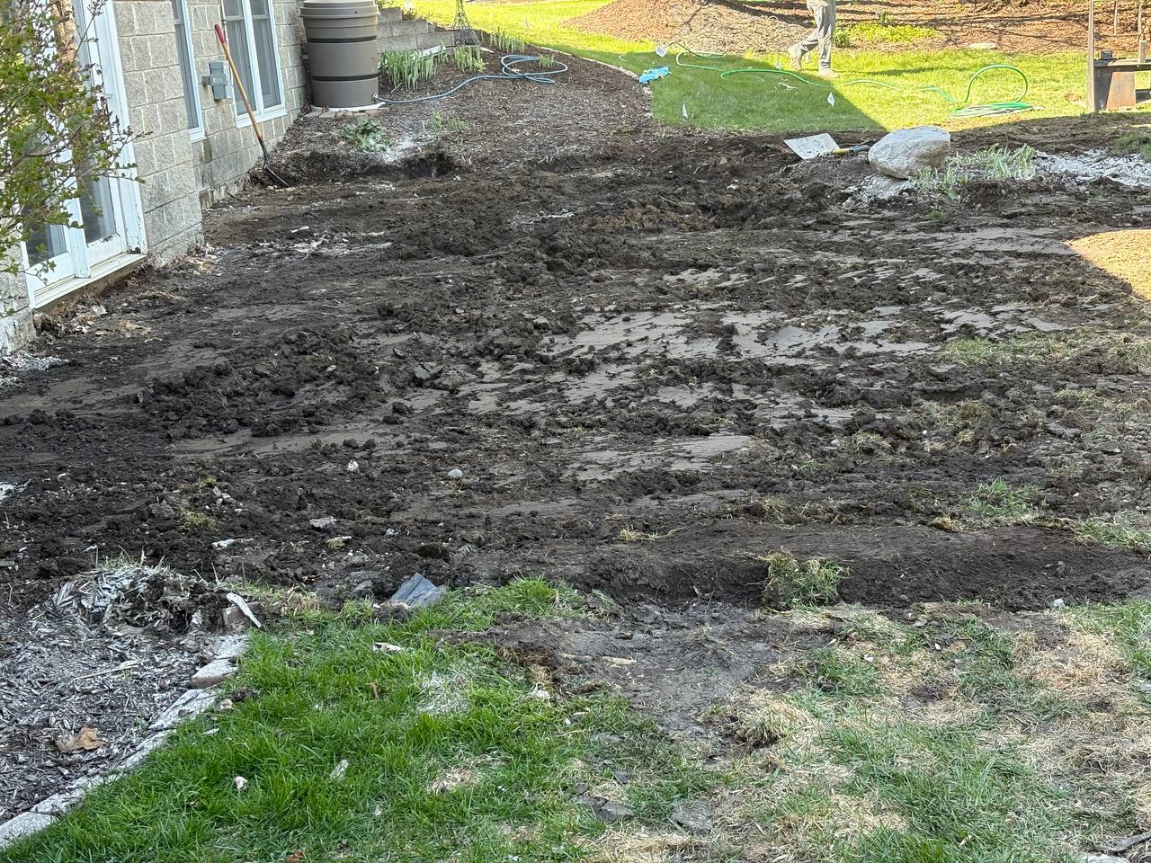 Twin Cities Concrete Demolition crew jackhammering concrete by hand to protect surrounding lawn