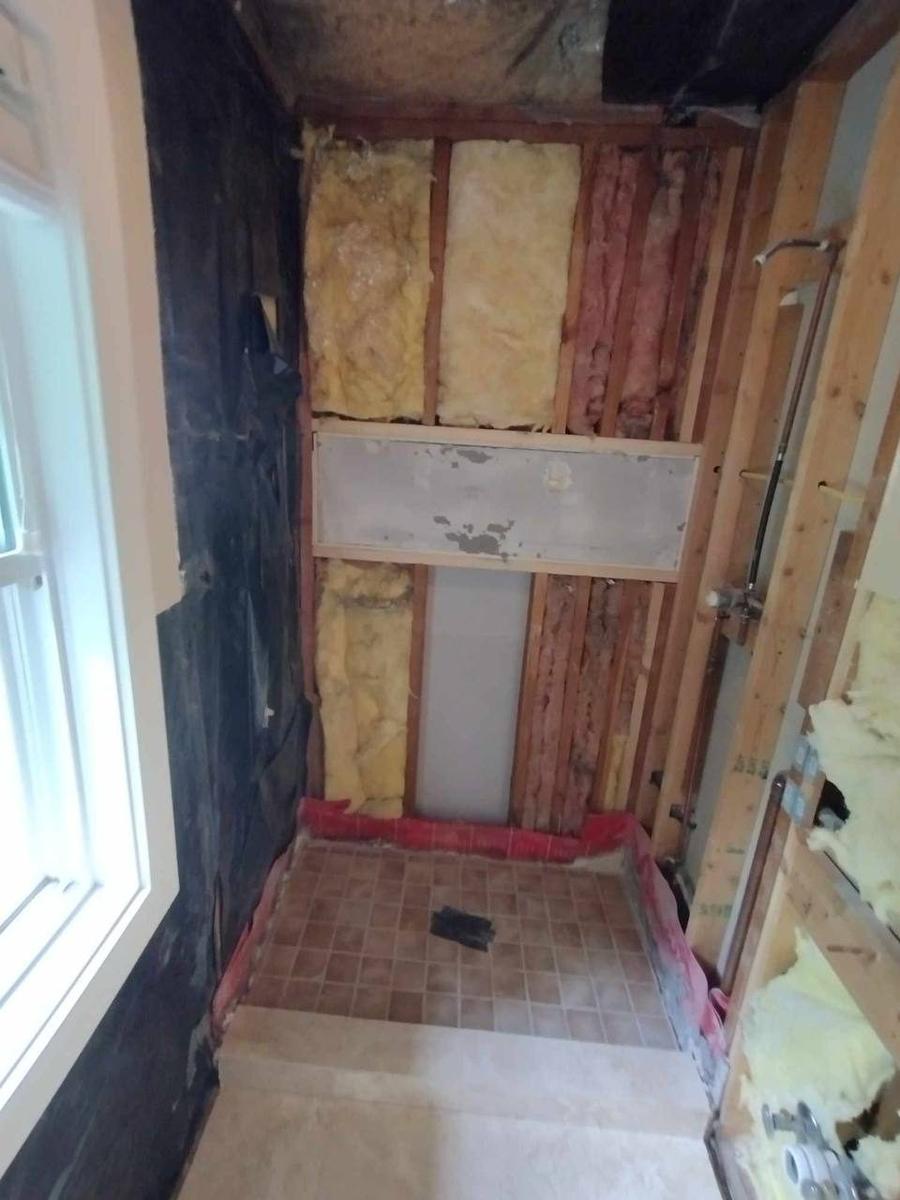 Interior bathroom demolition gut-out Minneapolis MN — studs exposed, ready for rebuild