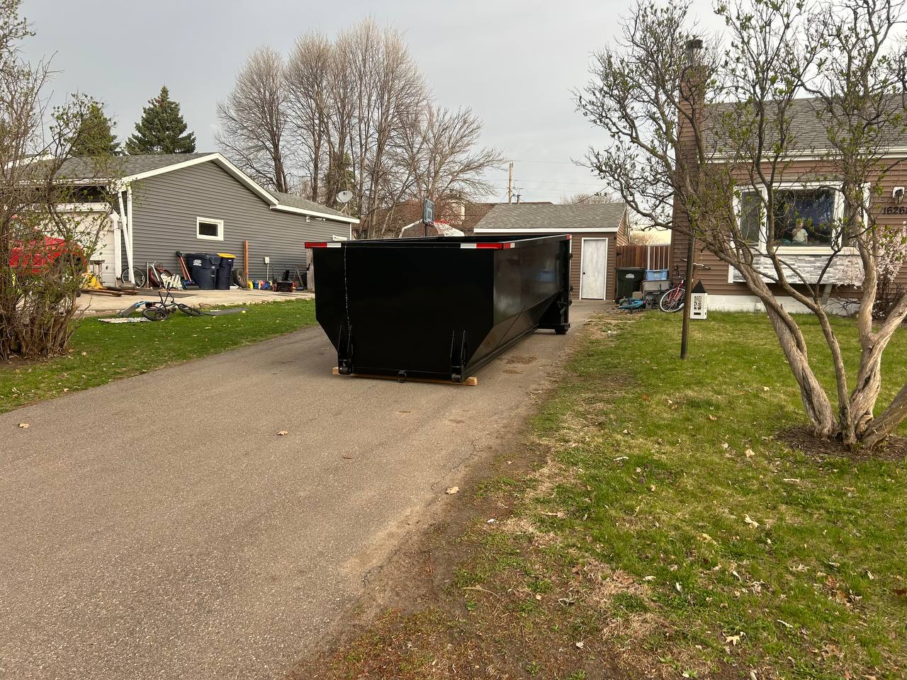 Roll-off dumpster rental delivered to residential driveway, Minneapolis MN
