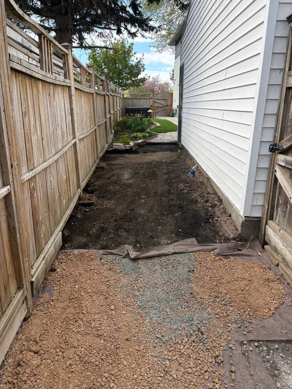 Narrow side yard concrete walkway between two homes prepped for demolition, Minneapolis